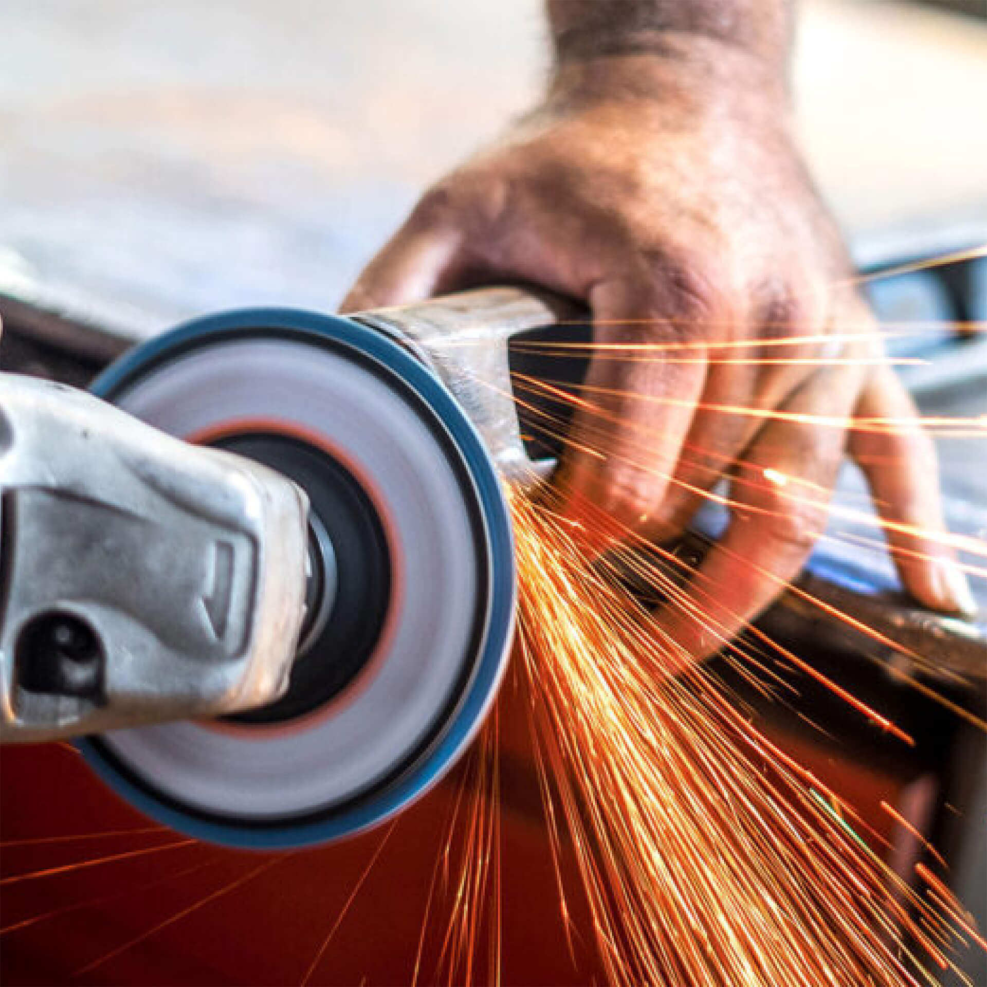 Close-up of an angle grinder cutting metal, throwing sparks